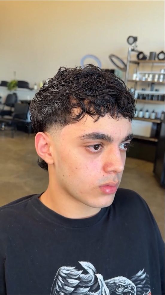 Curly textured fringe with low taper