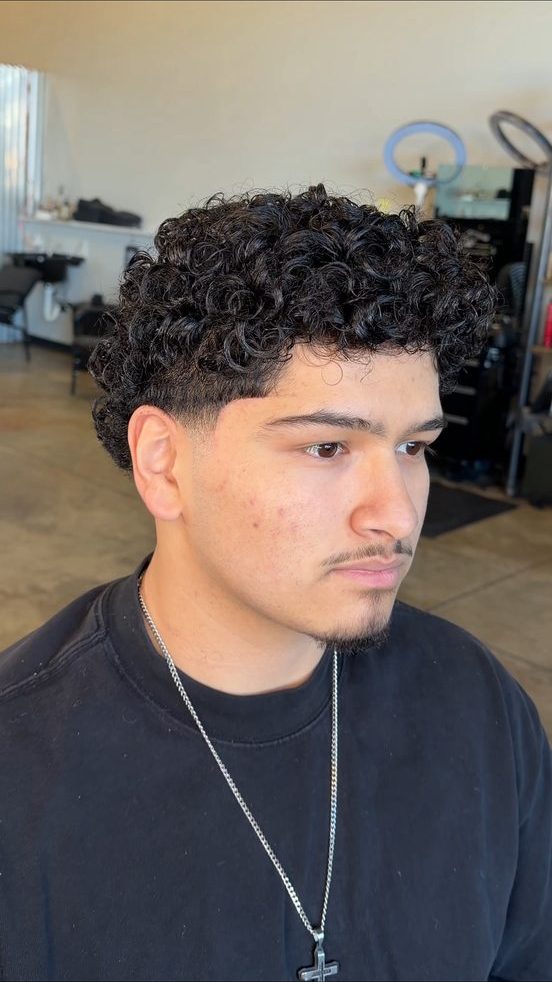 Thick curly cut with low taper